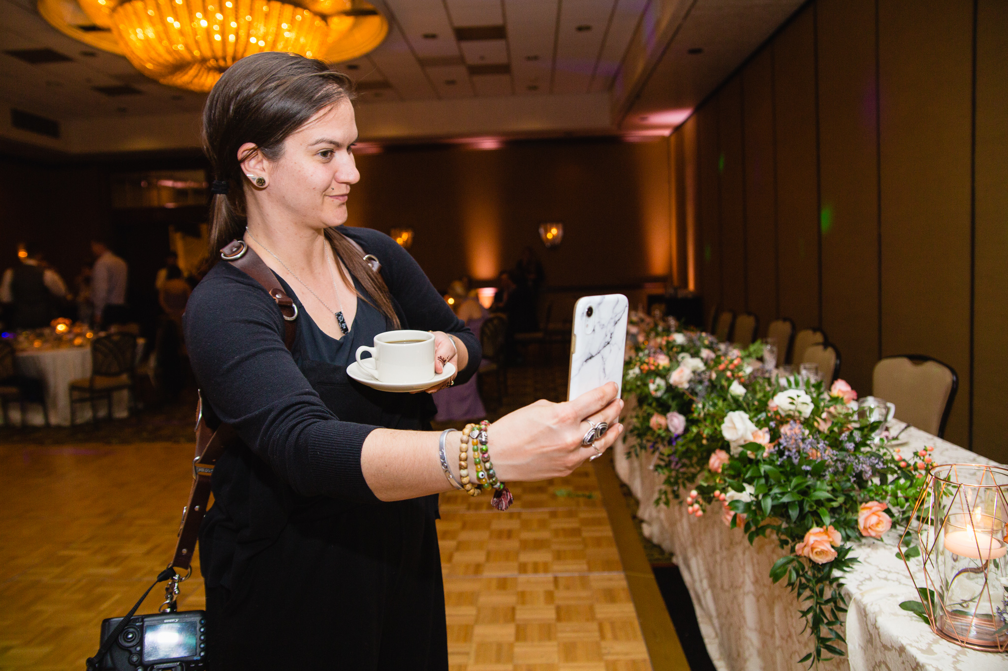 Jenn of PMA Photography taking a selfie with coffee at a reception.