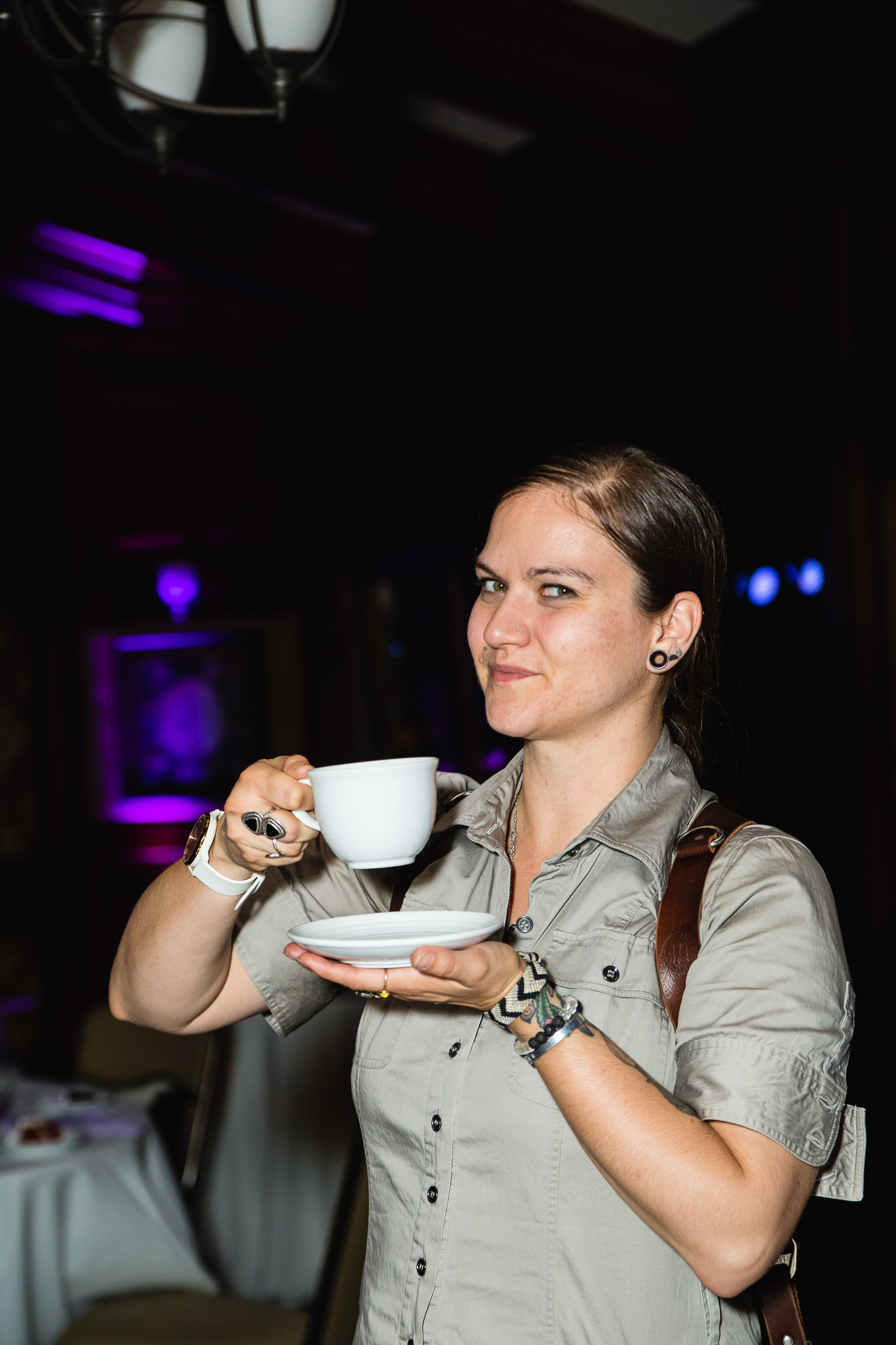 Jenn of PMA Photography drinking coffee during a reception.