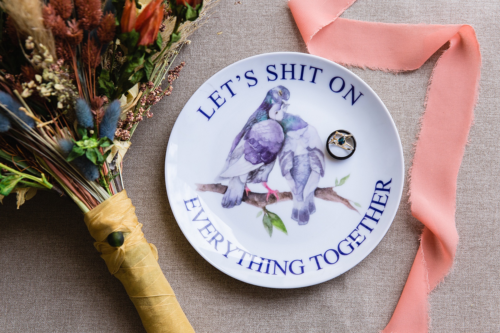 Funny wedding ring plate that says "let's shit on everything together" with an image of birds by Phoenix wedding photographer PMA Photography.