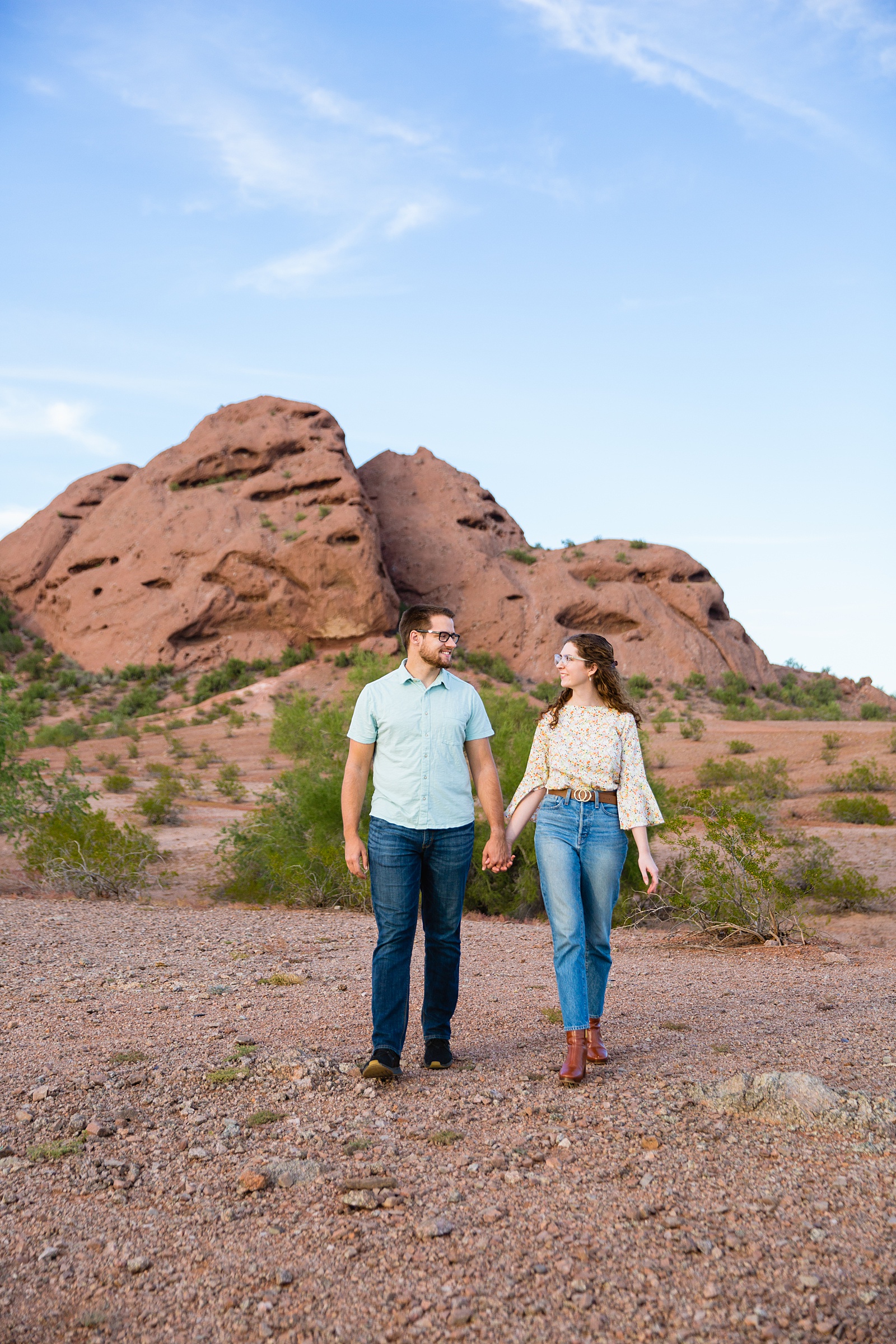 Couple walking together during their Papago Park engagement session by Phoenix engagement photographer PMA Photography.