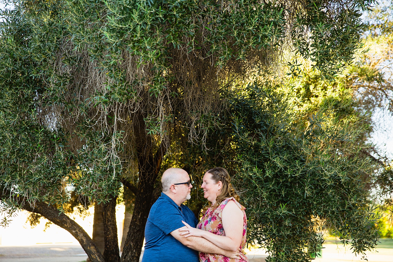 Couple share an intimate moment at their Glendale engagement session by Arizona engagement photographer PMA Photography.