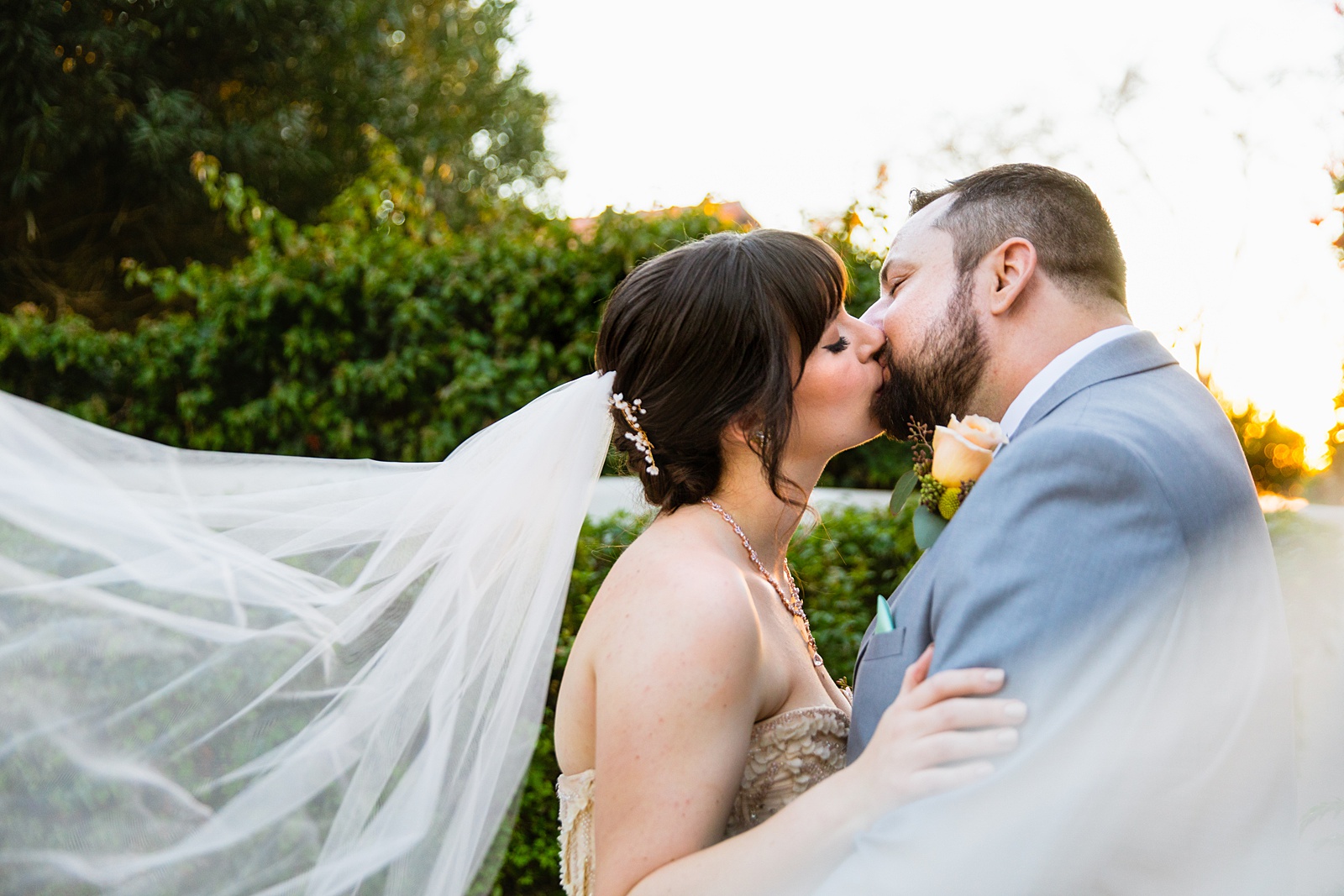 Bride and Groom share a kiss during their Bella Rose Estate wedding by Arizona wedding photographer PMA Photography.
