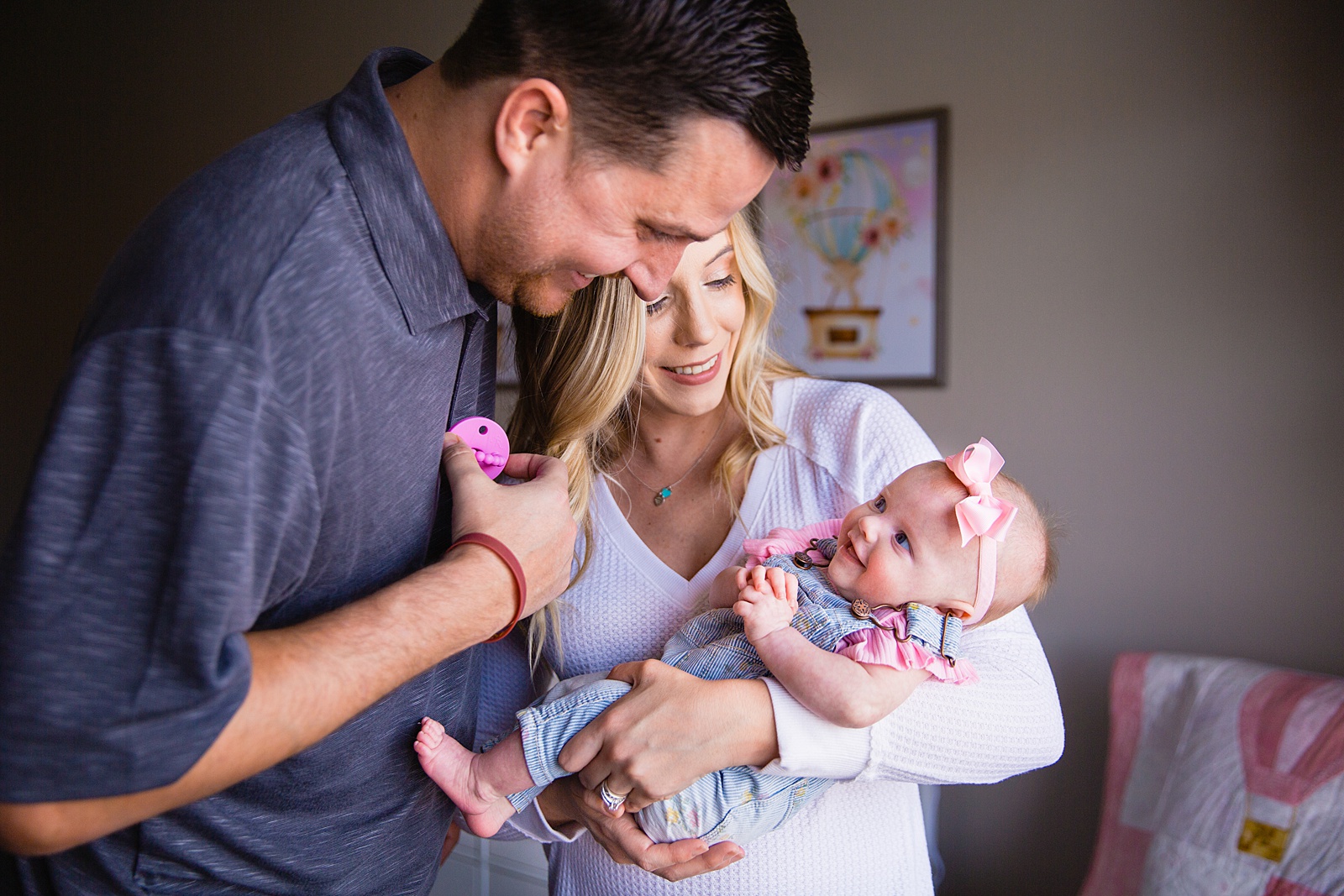 Family laughing together during their at home newborn family session by Phoenix family photographer PMA Photography.