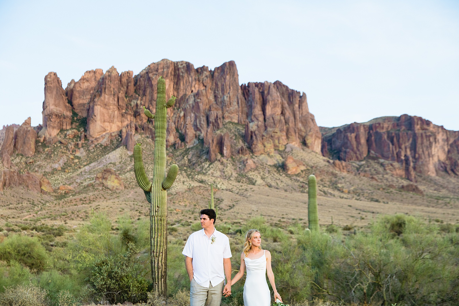 Bride and groom pose during their Superstition Mountain Micro wedding by Arizona wedding photographer PMA Photography.