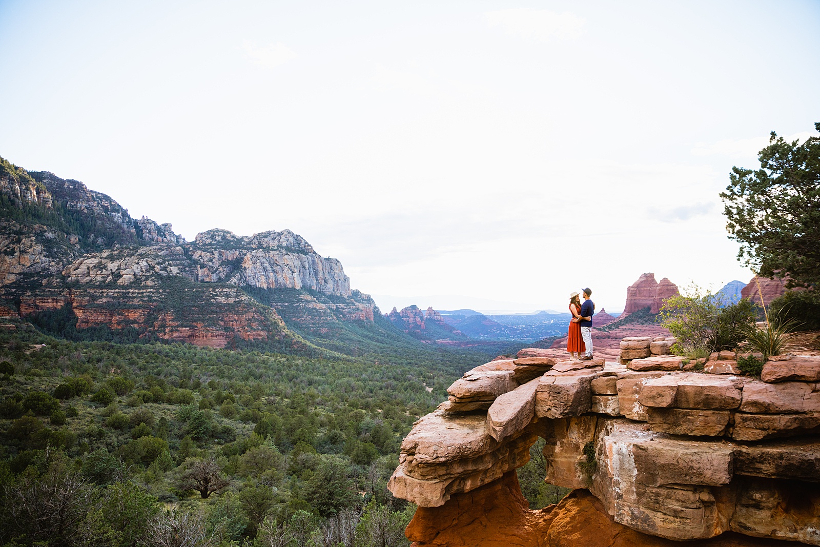 Couple look at each other during their Sedona engagement session by Arizona wedding photographer PMA Photography.