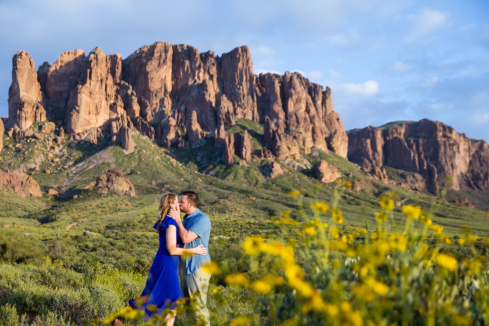 Couple share a kiss during their Superstitions Mountain engagement session by Apache Junction wedding photographer PMA Photography.