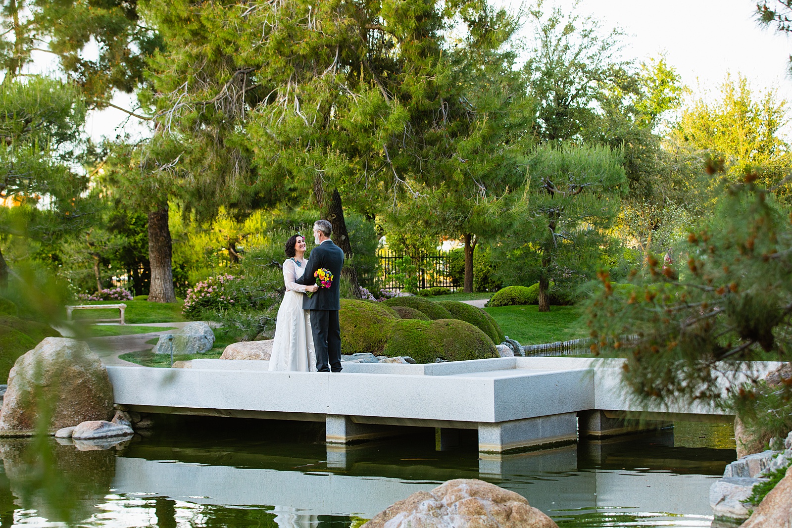 Bride and groom pose for their Japanese Friendship Garden wedding by Phoenix wedding photographer PMA Photography.