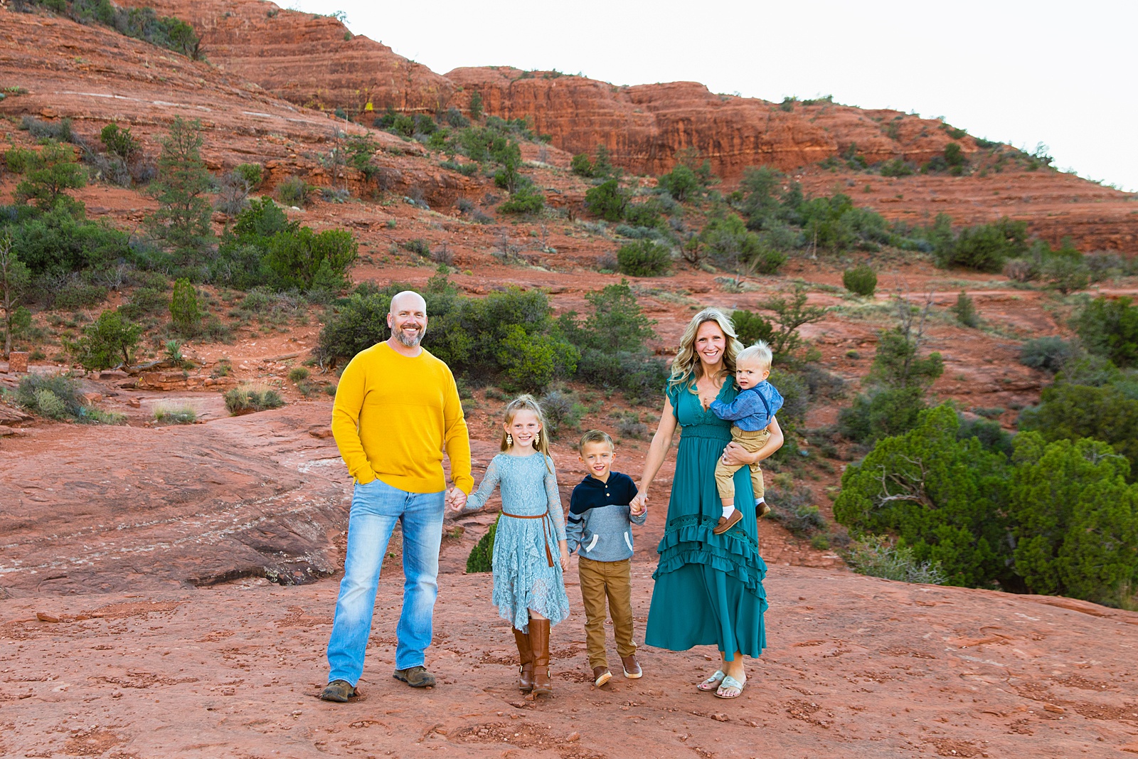 Family pose during their Sedona family session by Arizona family photographer PMA Photography.